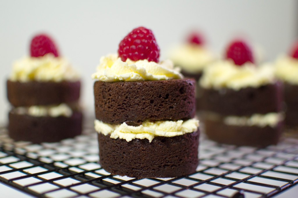 Individual Chocolate Cakes With Whipped Cream And Raspberries