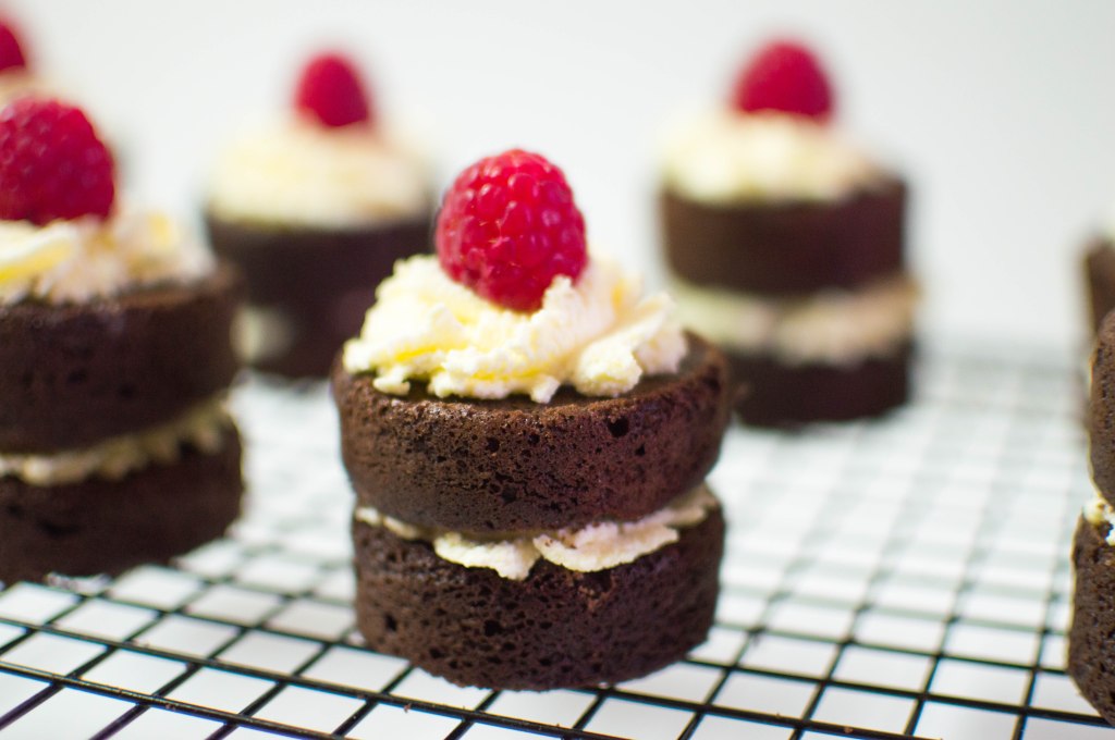 Mini Chocolate Cakes With Whipped Cream And Raspberries