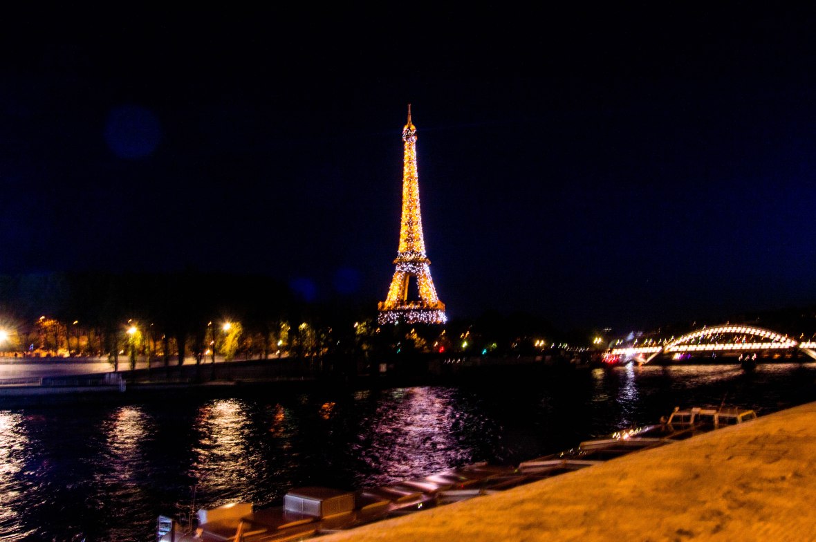 View Of Lit Up Eiffel Tower From Pont de l'Alma By Nightfall, Paris, France